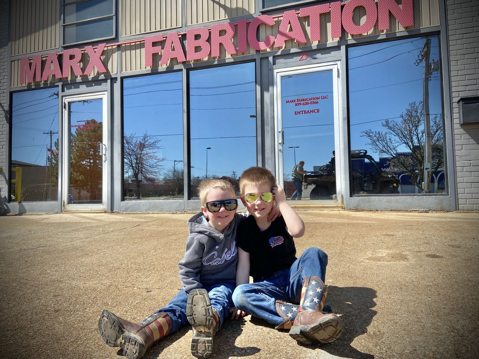 Founder Brent Marx’s sons Ben and Jack in front of the Marx Fabrication shop